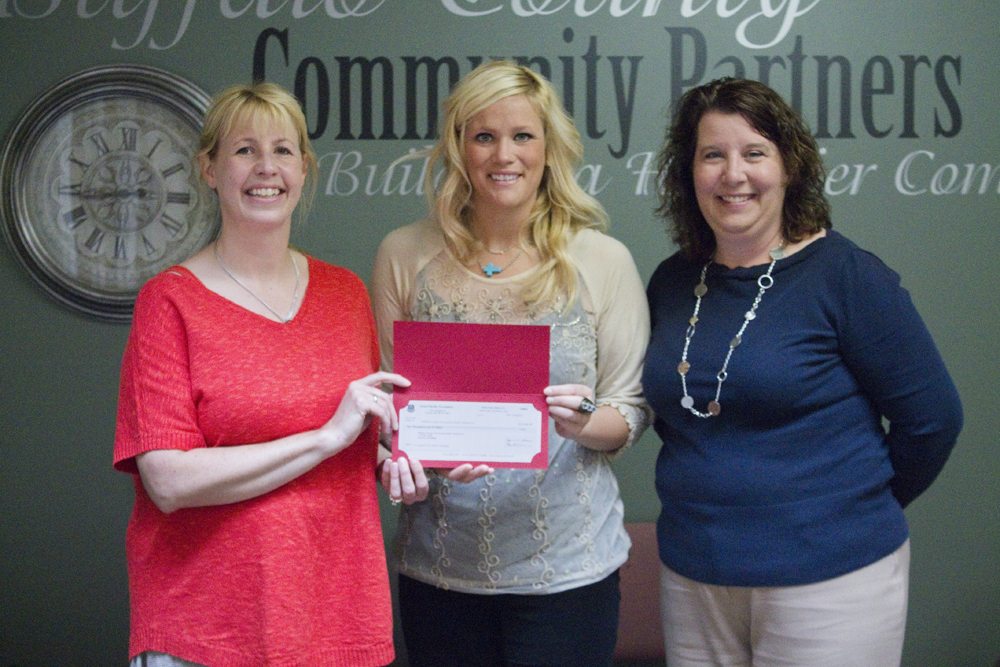 Kelli O’Brien of the Union Pacific Foundation presents a $10,000 check for Positive Pressure to Coalition Coordinator Tana Nelsen and Executive Director Denise Zwiener.